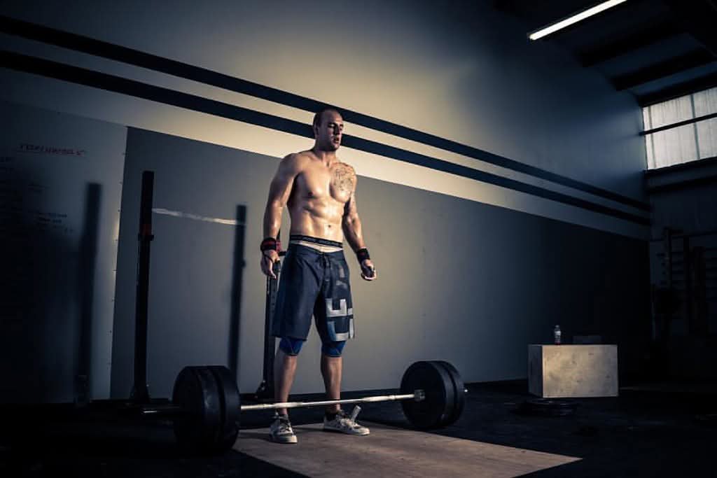 Athlete performing weightlifting training in a gym